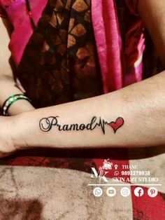 a woman with a tattoo on her arm that reads, pranam and has a heart