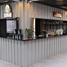 the bar is lined with bottles of alcohol and drinks on it's counter top