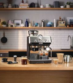 an espresso machine sitting on top of a wooden table