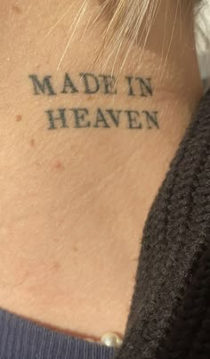 a woman with a tattoo on her neck that says made in heaven