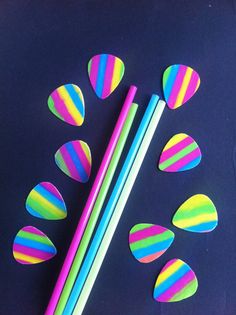 colorful paper straws and two pencils on a blue surface