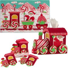 a cross stitch kit with santa's train and other items