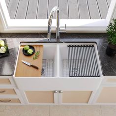 a kitchen sink with a cutting board and knife in it