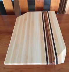 a wooden cutting board sitting on top of a table