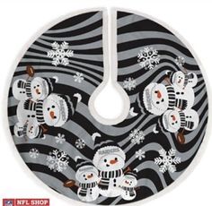 a black and white christmas tree skirt with snowmen on the front, in an abstract pattern