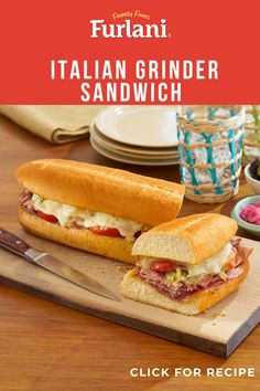 the italian grinder sandwich is cut in half on a cutting board with a knife