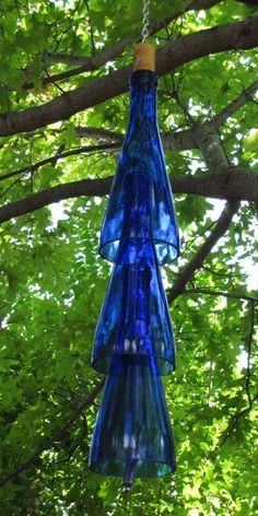 a blue glass bottle hanging from a tree