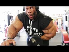 a man in black hoodie lifting a dumbbell