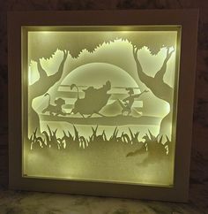 an illuminated paper cut scene of two people on a sleigh