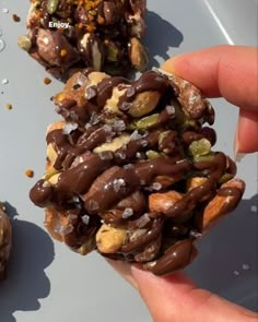 someone is holding some kind of food in their hand and it looks like they are made out of nuts