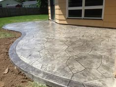 a concrete patio in front of a house