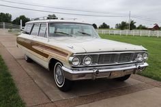 an old station wagon is parked on the sidewalk