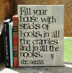 a stack of books sitting on top of a wooden table