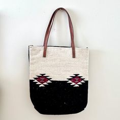 Our wool handbags are traditionally made by table loom by our artisan partners the Garcia Familia from Teotitlan de Valle, Oaxaca, Mexico. A versatile bag that can be worn on any occasion. Size: 15 1/2" H x 15" W (with strap 26" H) Material: 100% Wool Note: Due to the nature of handmade products, there may be minor variations in size and color. Wool Handbags, Table Loom, Flower Planters, The Nature, Handmade Products, Black Wool, Flower Vases, Light Gray, Candle Decor