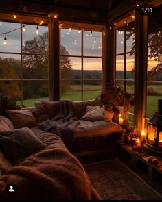 a living room filled with lots of furniture and lights on the windows sills