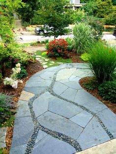 a stone path in the middle of a garden