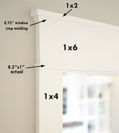 measurements for the top and bottom of a window frame in a room with white walls