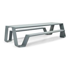 a gray bench sitting on top of a white floor next to a metal frame structure