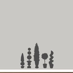 the silhouettes of trees and plants against a gray background