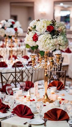 the centerpieces are adorned with red and white flowers