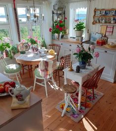 a kitchen filled with lots of furniture and flowers