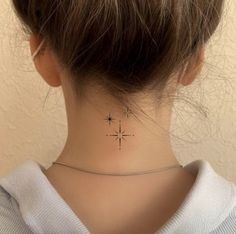 a woman's neck with a small star tattoo on her left side ribcage