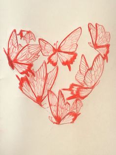 some red butterflies are flying in the shape of a heart on a white paper background