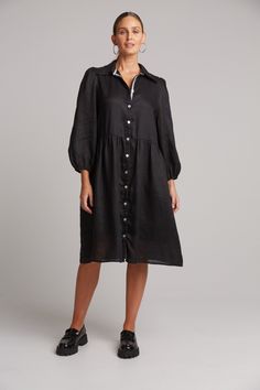 STYLE DETAILS: Shirt dresses are one of those nostalgic trends that always seem to make a comeback. The Studio Midi Shirt Dress is the perfect piece for everyday wear, made from luxurious linen. It features a button-down front and long balloon sleeves for a relaxed yet stylish look. The inside placket is lined with a contrast ribbon, adding extra detail. Pair it with sneakers or boots to suit your occasion. FEATURES: Collar Button-down Balloon sleeves Gathered waist Midi length 100% Linen Lining: 100% Rayon Contrast: 100% Polyester XS, S, M, L, XL Black Shirt Dress With Placket For Spring, Spring Formal Dress With Relaxed Fit, Knee-length Daywear Dresses With Button Cuffs, Chic Dress With Button Cuffs And Relaxed Fit, Black Collared Dress With Relaxed Fit, Chic Dresses With Button Cuffs And Relaxed Fit, Black Relaxed Fit Collared Dress, Black Collared Dress With Button Cuffs, Elegant Relaxed Fit Midi Dress With Buttons