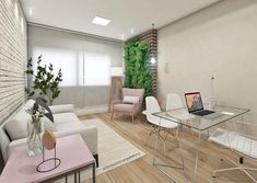 a living room filled with furniture and a laptop computer on top of a glass table