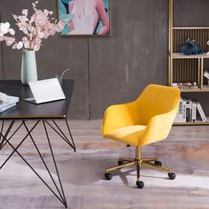 a yellow chair sitting next to a black table