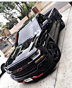 a black range rover parked on the side of a street