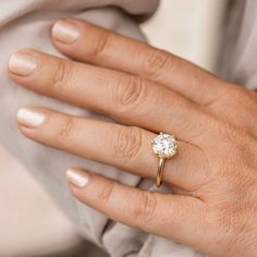 a woman's hand with a diamond ring on it