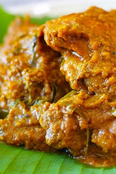 chicken rendang curry on a green plate with the words, chicken rendang curry