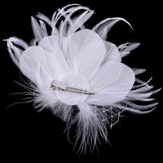 The 1920s fashion style is often remembered for its glitz and glamour, and this exquisite bridal hair accessory makes no exception. Bold and beautiful, it is adorned with white feathers and intricately faceted crystals that capture the light from every angle with a perfectly translucent appeal.5.1" (approx. 13cm) tall by 7" (approx. 18cm)wide. This beautiful hair accessory coordinates with any color wedding dress and it gives your hair an extra touch of glam to finish off your perfect look on yo