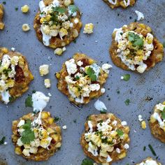 several appetizers are arranged on a baking sheet and ready to be eaten,