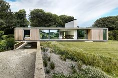 the house is surrounded by grass and trees