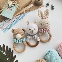 three crocheted stuffed animals on wooden rings