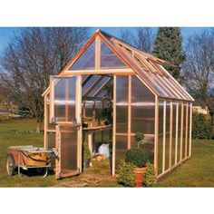 a small greenhouse in the middle of a yard