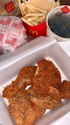 fried chicken and french fries in a white box