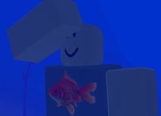 there is a goldfish in the water next to a white block with a smile on it's face