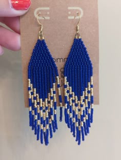 a pair of blue and gold beaded earrings