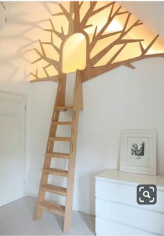 a room with a ladder and a tree lamp