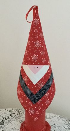 an ornament made to look like a santa hat on top of a table