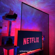 a television screen with the netflix logo lit up in red and blue lights at night