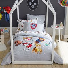 a child's bedroom with toys and decorations on the walls, including a white canopy bed