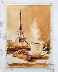 a painting of the eiffel tower and a cup of coffee