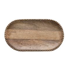 an oval wooden tray with beaded trim