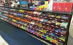 a grocery store filled with lots of different types of food and drinks on display in the aisle