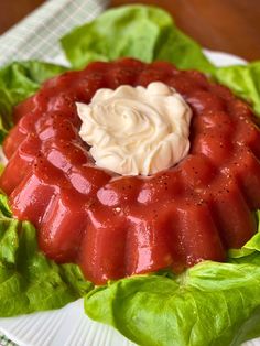 a plate topped with lettuce covered in sauce