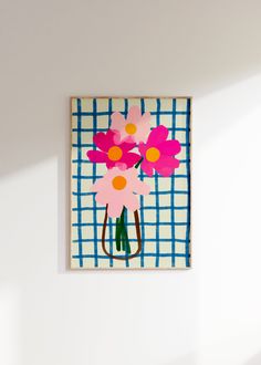 a painting with pink flowers on a blue and white checkered wall